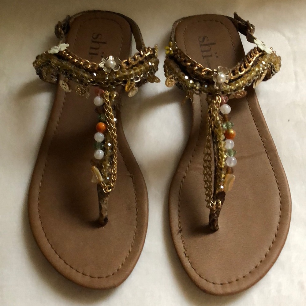Sandals with gold chains & charms.